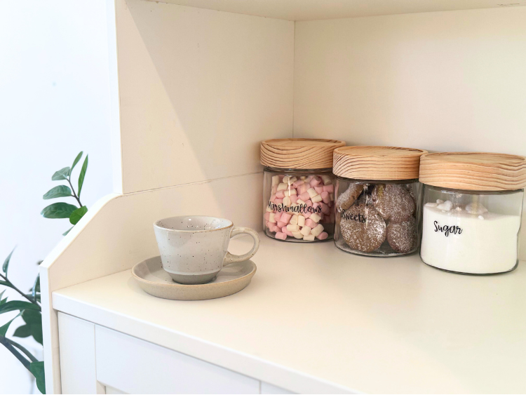 Marshmallows, Biscuits and sugar jars with a cup of tea