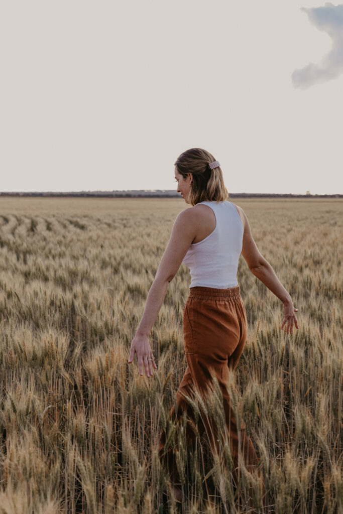 Person walking through wheat field