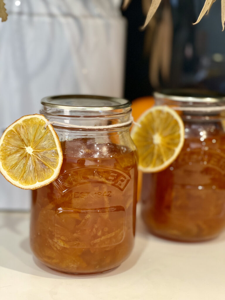 Jar of mandarin marmalade with dried orange decoration