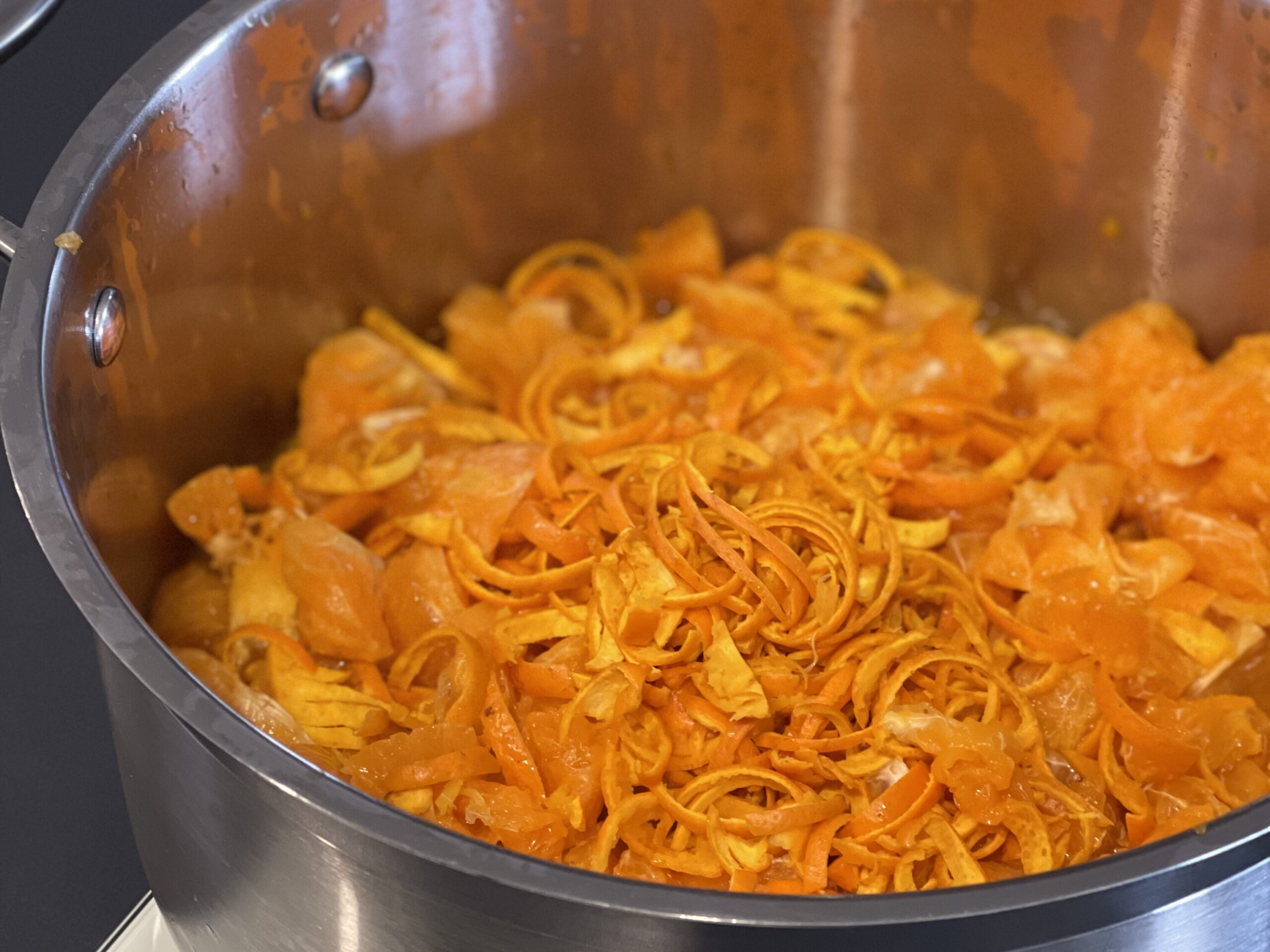 Weighing mandarin and the peel into a pot for making mandarin marmalade