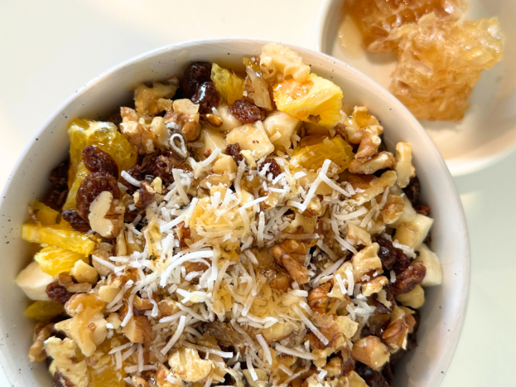 Bowl of breakfast ingredients with honey